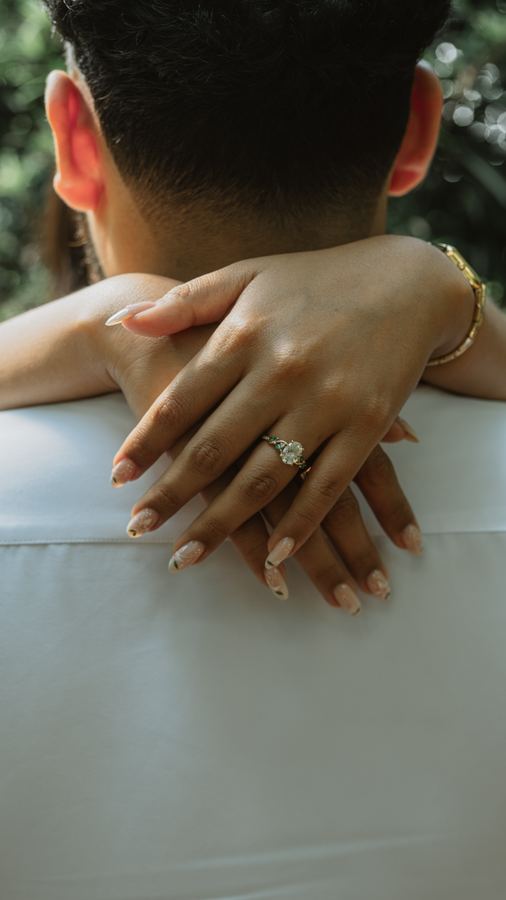 Jasmin's arms wrapped around Edgar, ring in view