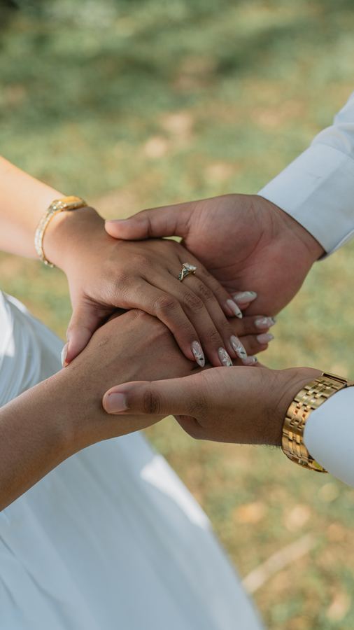 Their hands stacked together, showing the ring
