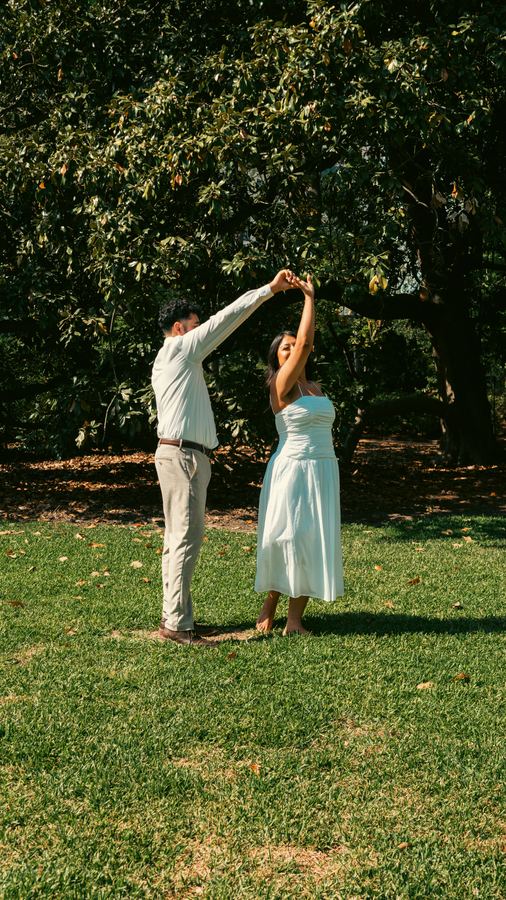Edgar twirling Jasmin on the lawn